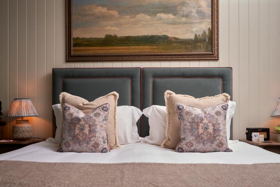 The Farrier - Wonderful Winchcombe A painting of English countryside hangs above a large bed with decorative cushions